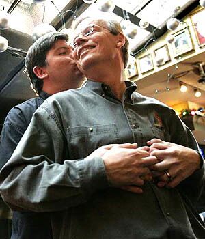 Joe Varnell, left, and Kevin Bourassa, who became Canadas first legally married gay couple in 2001, welcome the courts decision at a Toronto bar.