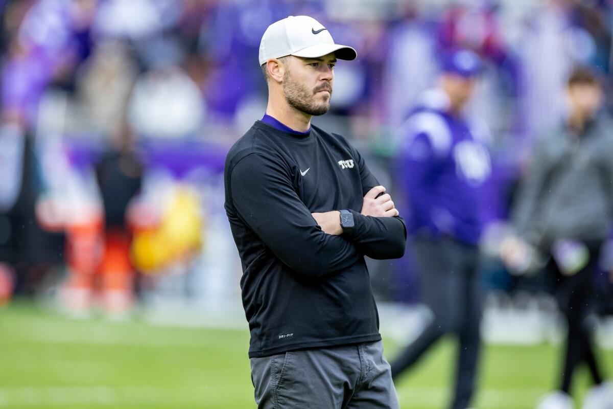 Texas Christian offensive coordinator Garrett Riley watches players warm up before a game against Iowa State in November.
