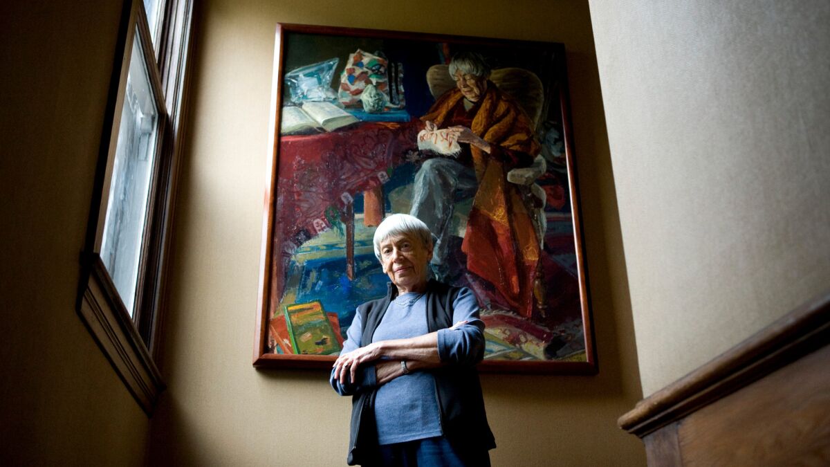 Celebrated science–fiction and fantasy writer Ursula K. Le Guin poses in front of a portrait painted by Henk Pander.
