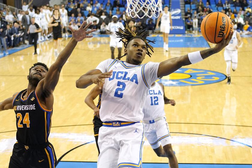 UCLA guard Dylan Andrews, right, shoots over UC Riverside guard Barrington Hargress during the first half at Pauley Pavilion.