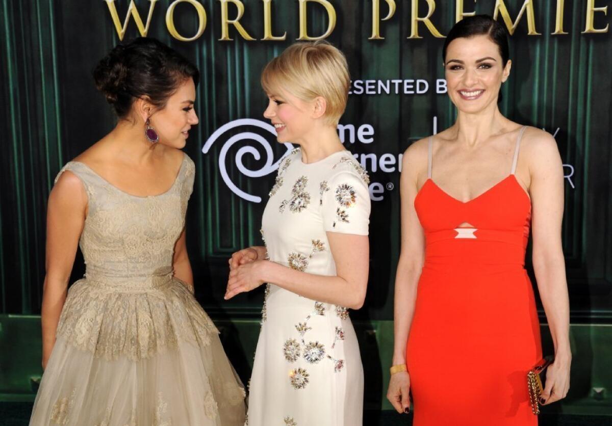 Mila Kunis, Michelle Williams and Rachel Weisz, left to right, arrive at the premiere of "Oz: The Great and Powerful."