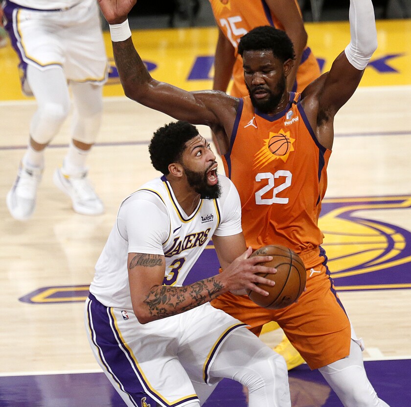 Lakers forward Anthony Davis, left, tries to work past Phoenix Suns center Deandre Ayton.