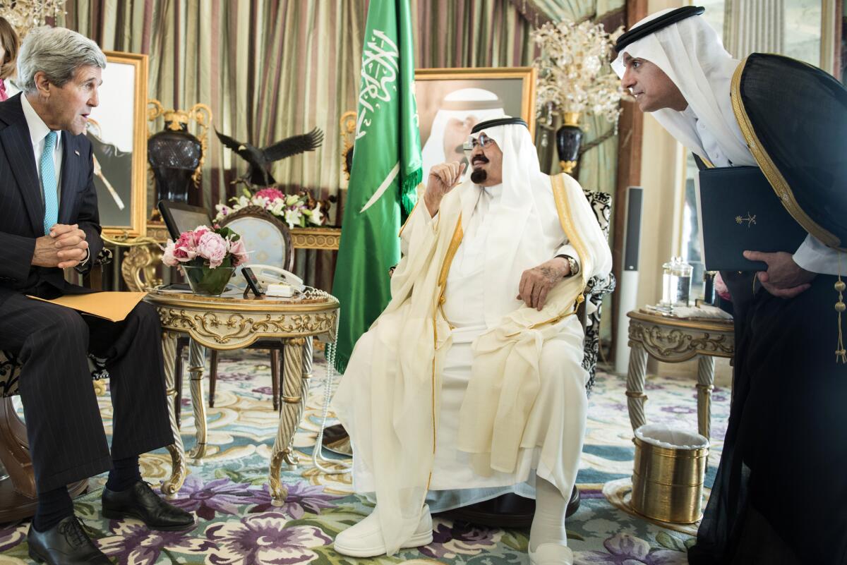 Adel Jubeir, right, then-Saudi ambassador to the United States, listens to U.S. Secretary of State John F. Kerry while interpreting for King Abdullah at the king's private residence in Jidda on June 27, 2014.