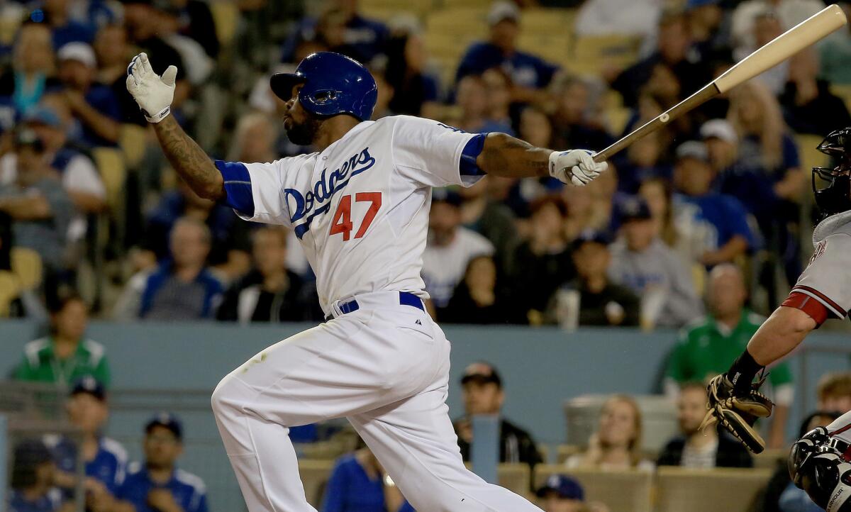 Dodgers second baseman Howie Kendrick strokes a solo home run against the Diamondbacks in the sixth inning.