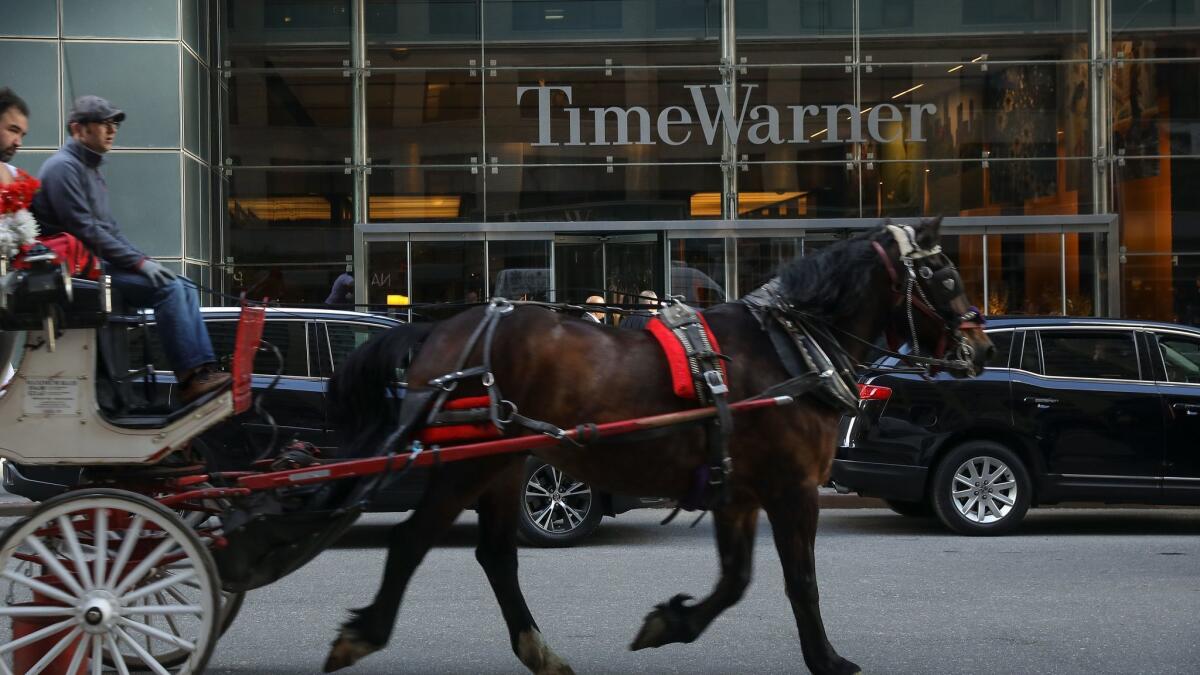AT&T on Thursday closed its $85-billion purchase of Time Warner, above, based in New York.