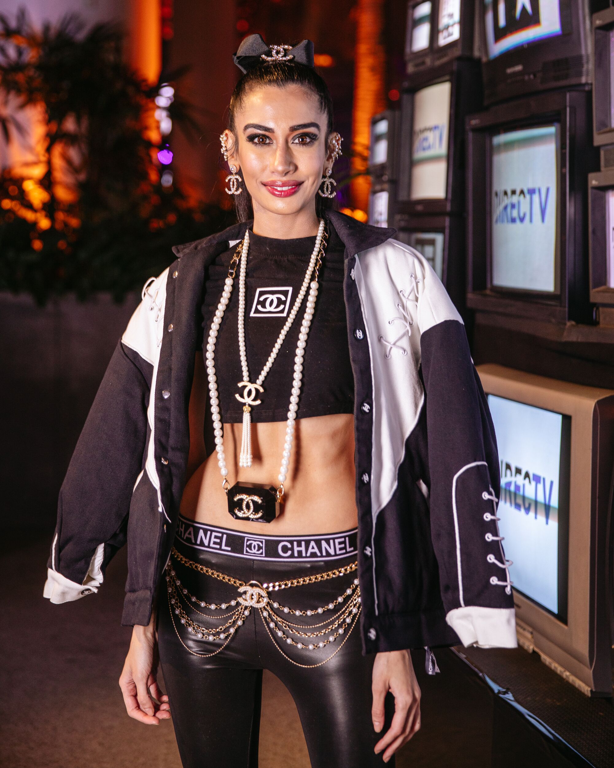 A woman in a black and white jacket poses for a portrait.