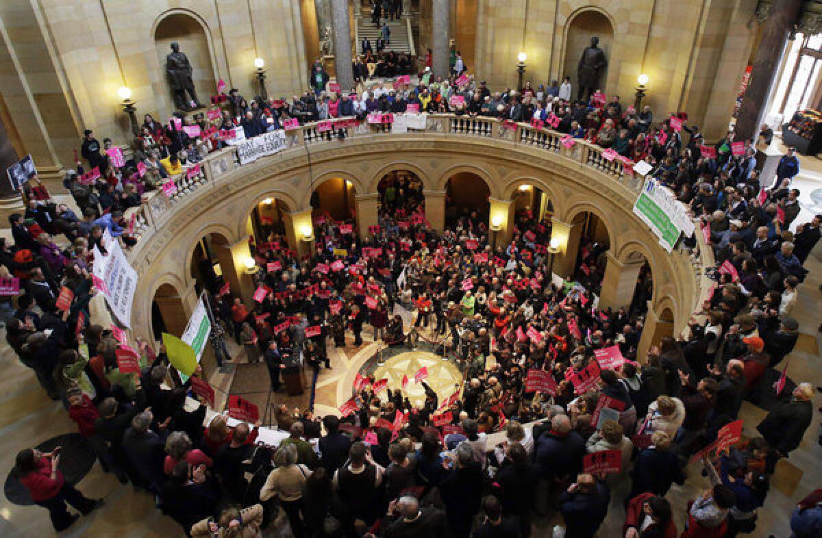 Supporters and opponents of a bill to legalize gay marriage in Minnesota gather in the state Capitol rotunda in St. Paul, where the battle over gay marriage shifts after Delaware's vote Tuesday.