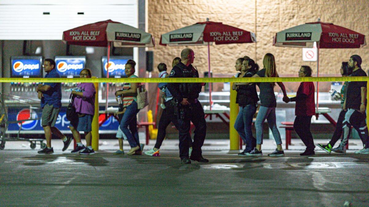 Customers were led out of a Costco in Corona after a shooting by an off-duty LAPD officer left one man dead and his parents seriously injured.