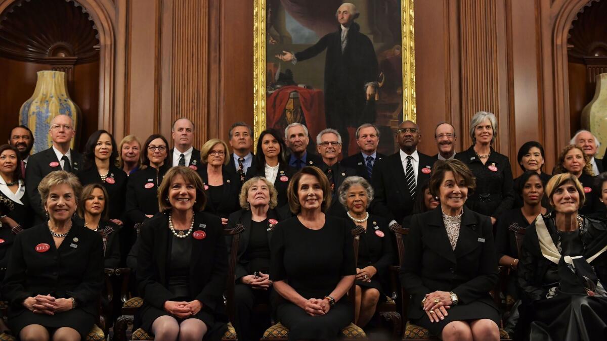 Pelosi poses with members of Congress wearing black in support of the "metoo" movement in the Rayburn Room of the US Capitol.