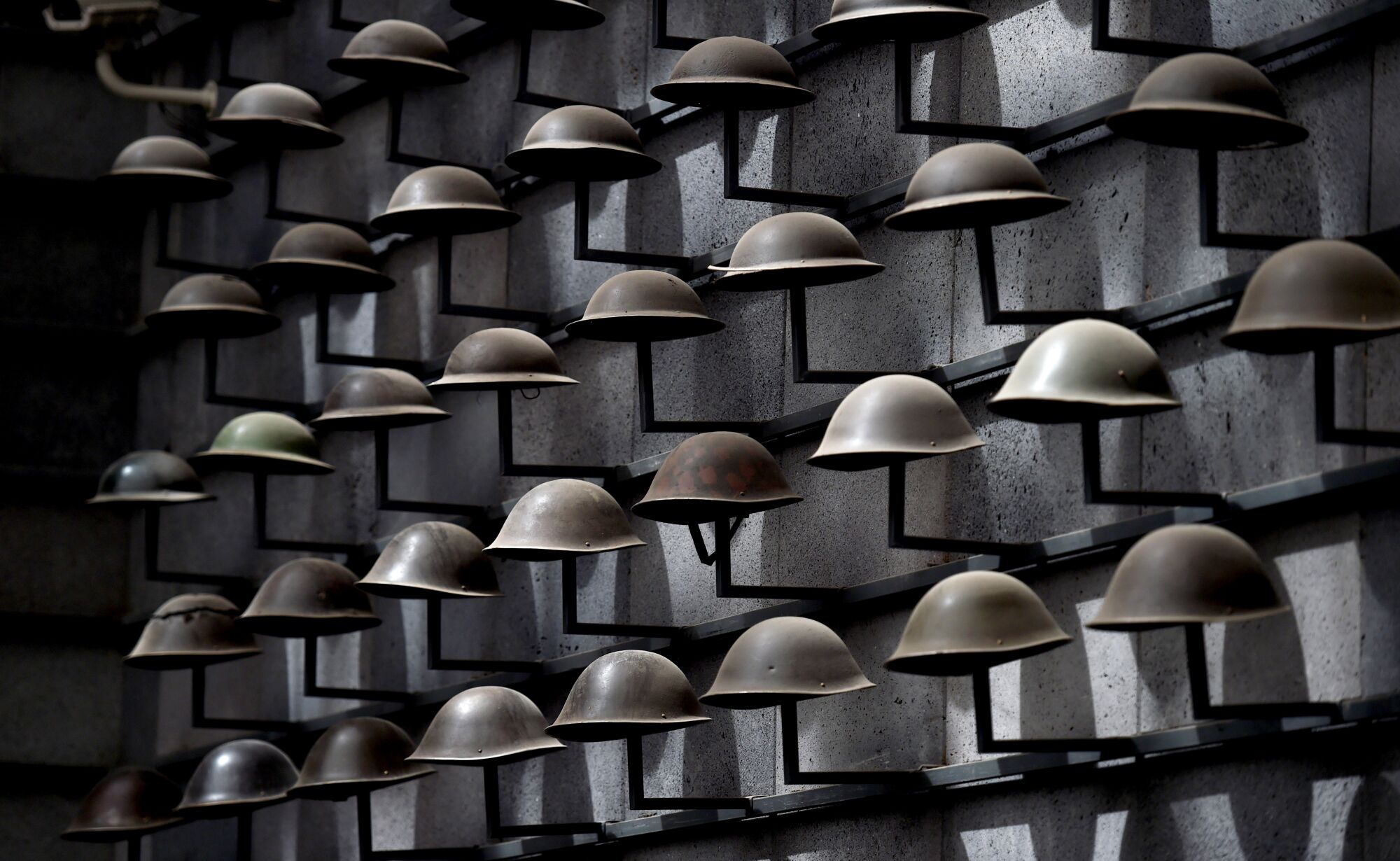 Military helmets on display at the martyrs cemetery museum in Tengchong, China.
