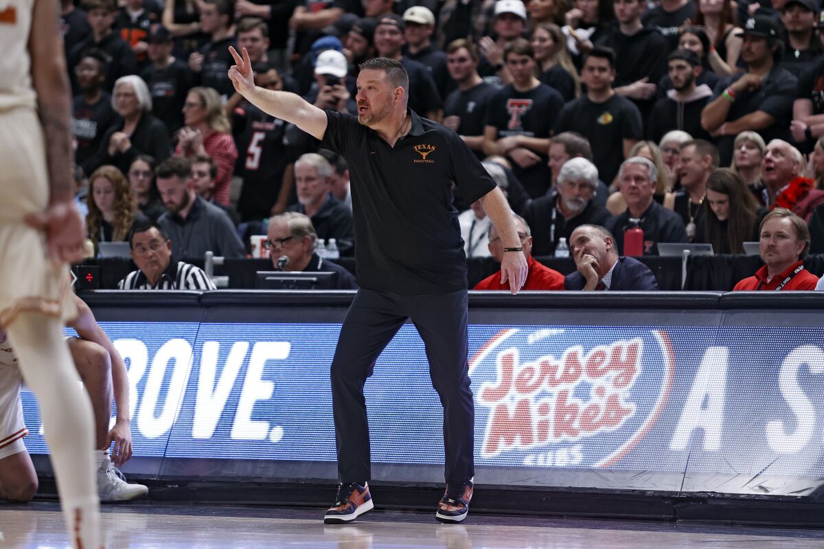 Texas coach Chris Beard yells out to his players during the first half of an NCAA college basketball game against Texas Tech, Tuesday, Feb. 1, 2022, in Lubbock, Texas. (AP Photo/Brad Tollefson)