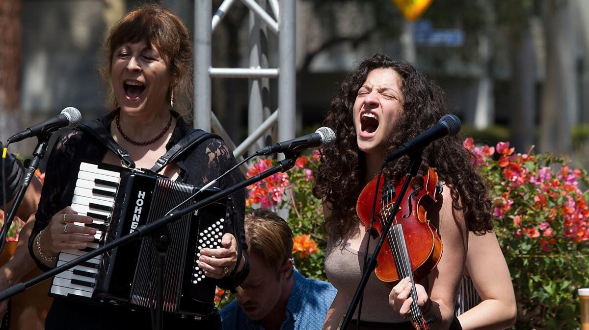 "Once" cast members Diane King Vann, left, and Marnina Schon perform during a noontime concert in front of South Coast Repertory on Aug. 23.