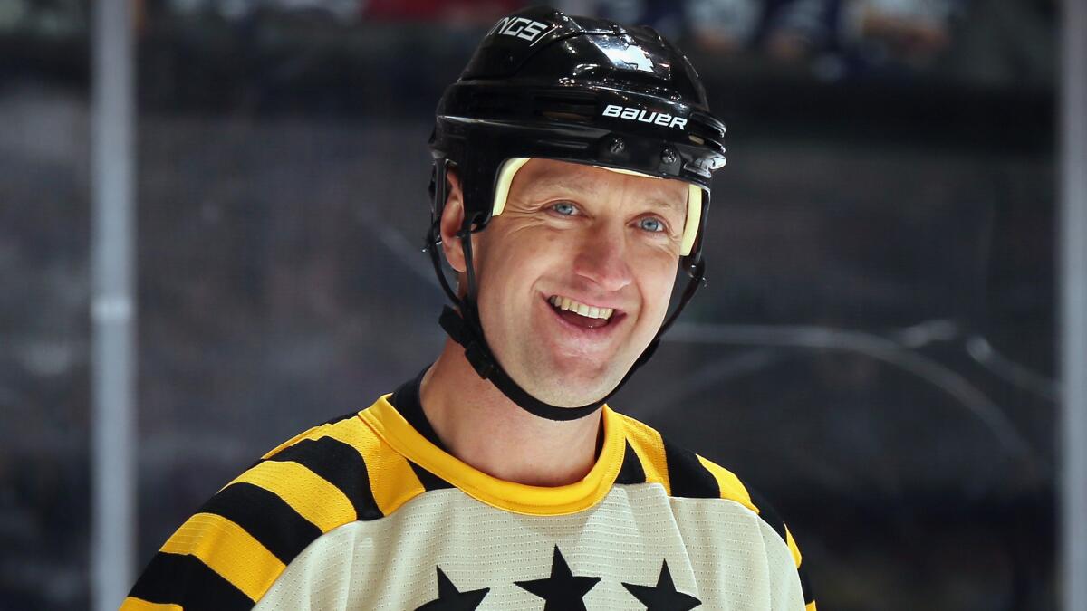 Former Kings defenseman and Hockey Hall of Fame inductee Rob Blake smiles while taking part in the annual legends hockey game in Toronto on Sunday.
