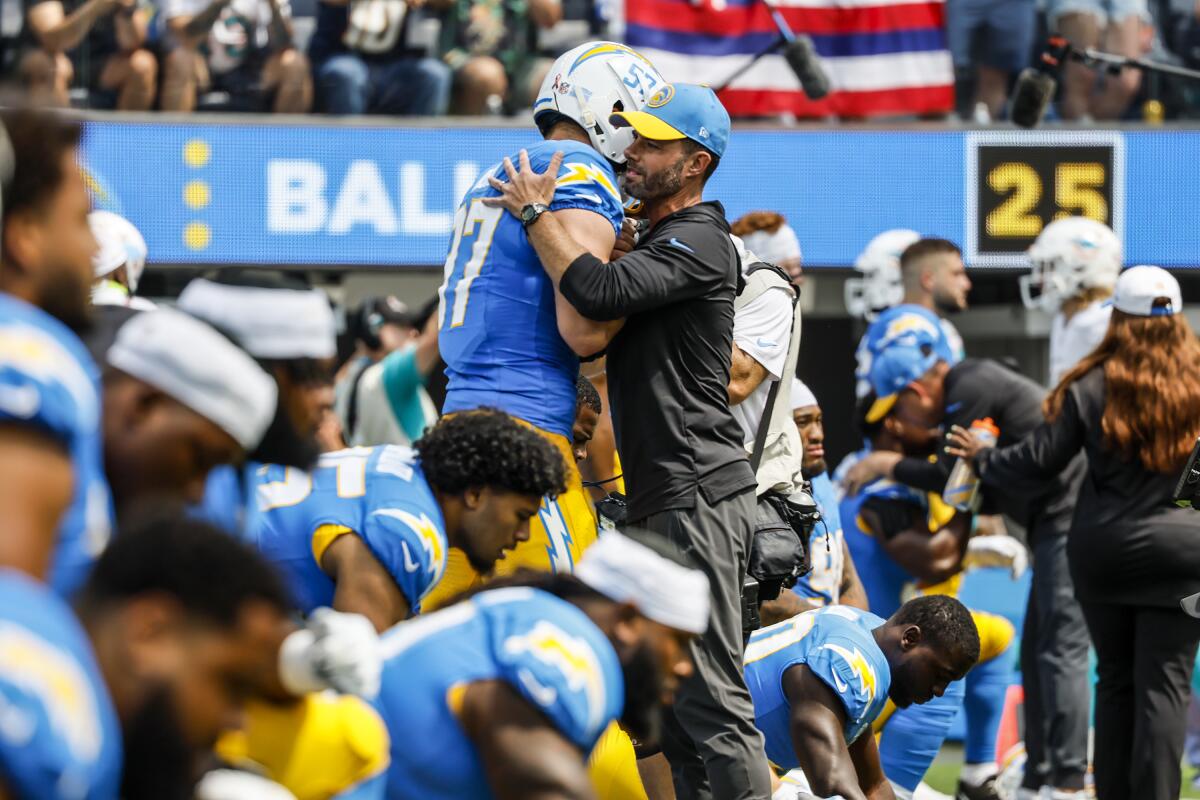 Chargers coach Brandon Staley embraces linebacker Joey Bosa before a season-opening loss to the Miami Dolphins.