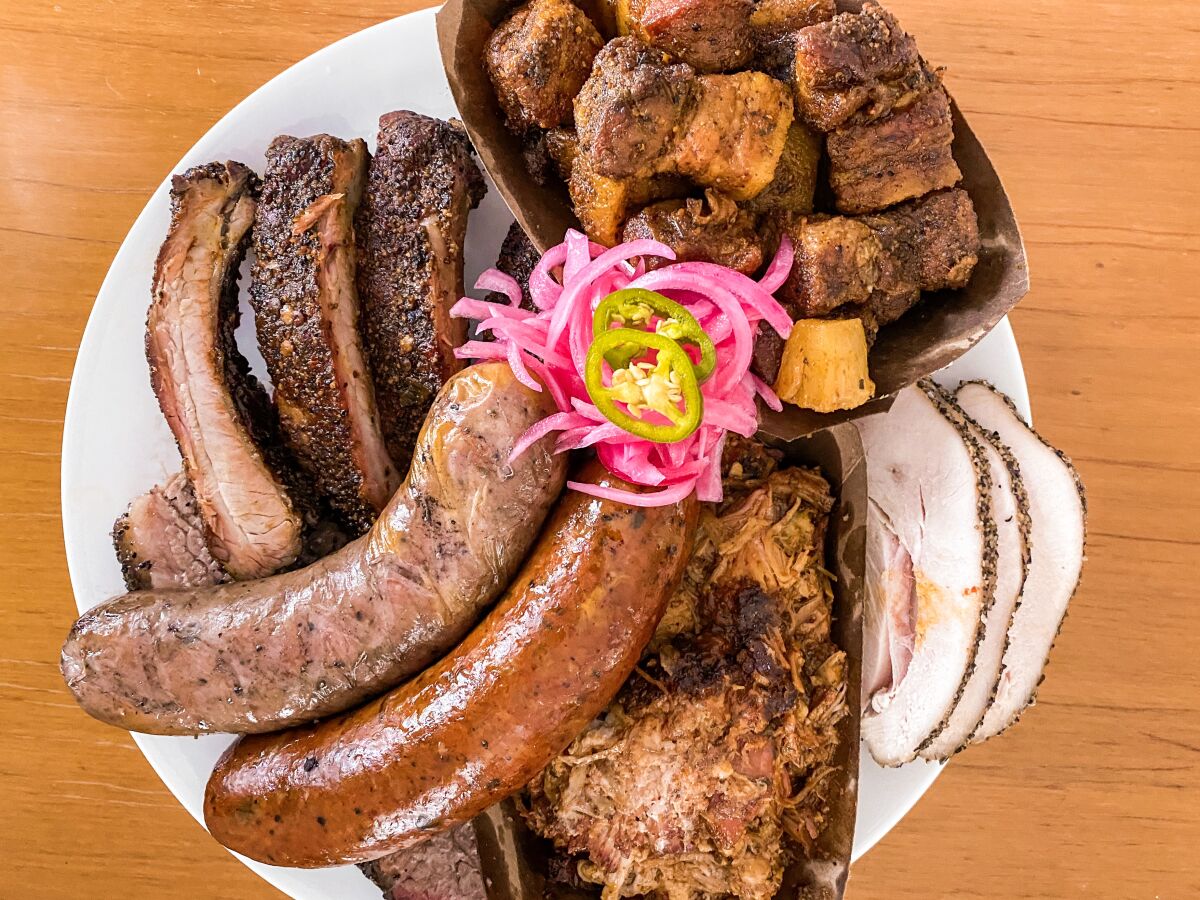 A platter of cochinita pibil-style pulled pork and other smoked meats from A's BBQ.