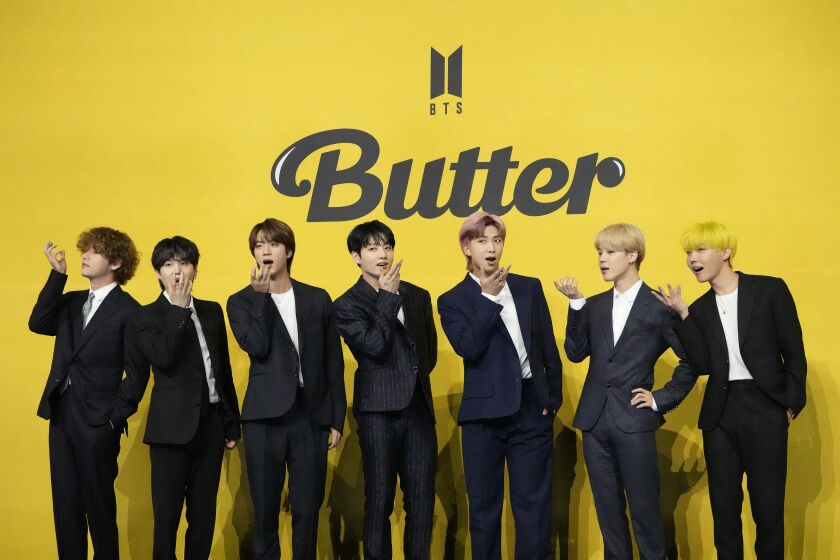FILE- Members of South Korean K-pop band BTS, V, SUGA, JIN, Jung Kook, RM, Jimin, and j-hope from left to right, pose for photographers ahead of a press conference to introduce their new single "Butter" in Seoul, South Korea, Friday, May 21, 2021. South Korea’s military appears to want to draft members of the K-pop supergroup BTS for mandatory military duties, as the pubic are sharply divided over whether they must be exempted from the service. (AP Photo/Lee Jin-man, File)