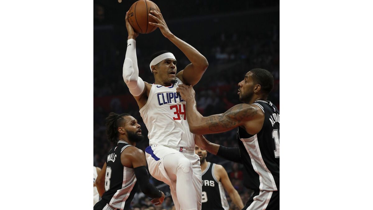 Clippers forward Tobias Harris gets fouled by Spurs forward LaMarcus Aldridge on the way to the basket in the first quarter.