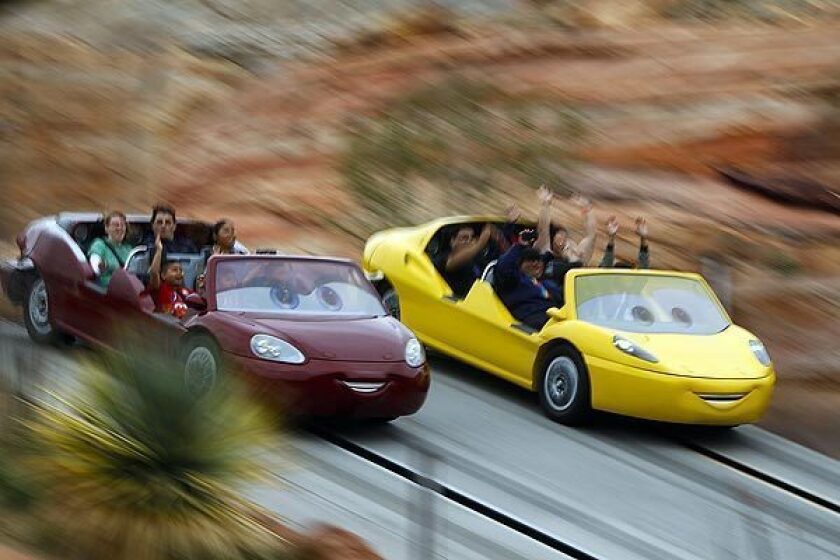 Riders experience the Radiator Springs Racers attraction at Disney California Adventure on the opening day of Cars Land.
