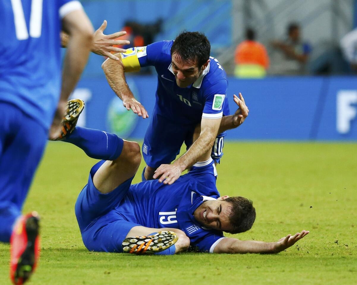 Greece's Papastathopoulos celebrates after scoring a goal with teammate Karagounis during their 2014 World Cup round of 16 game against Costa Rica at the Pernambuco arena in Recife