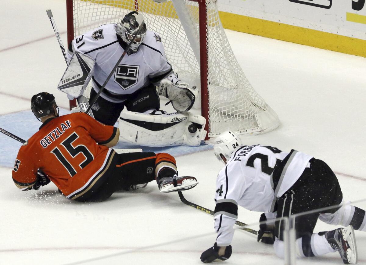 A shot by Anaheim Ducks center Ryan Getzlaf (15) is stopped by Kings goalie Peter Budaj (31) as defenseman Derek Forbort (24) is called for tripping in the third period on Sunday.