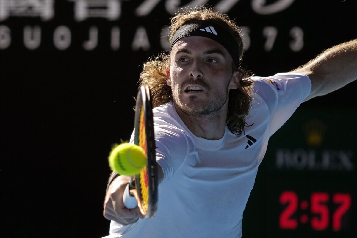 Stefanos Tsitsipas plays a backhand return to Karen Khachanov at the Australian Open.