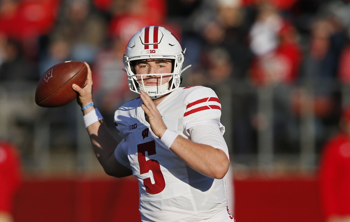 FILE - Wisconsin quarterback Graham Mertz (5) throws a pass against Rutgers during the first half of an NCAA football game, Saturday, Nov. 6, 2021, in Piscataway, N.J. Wisconsin’s fortunes the last two seasons generally have depended on how well quarterback Graham Mertz has protected the football. (AP Photo/Noah K. Murray, File)