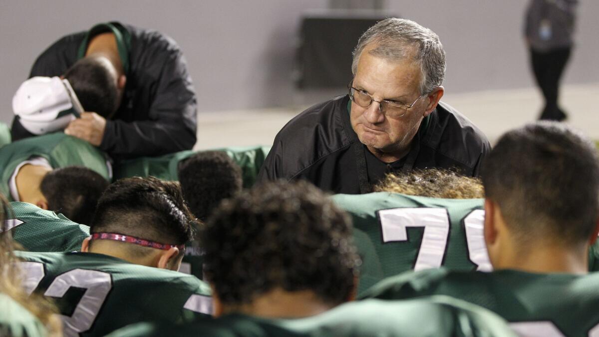 Oceanside coach John Carroll talks to his team after its loss to Folsom in 2014.