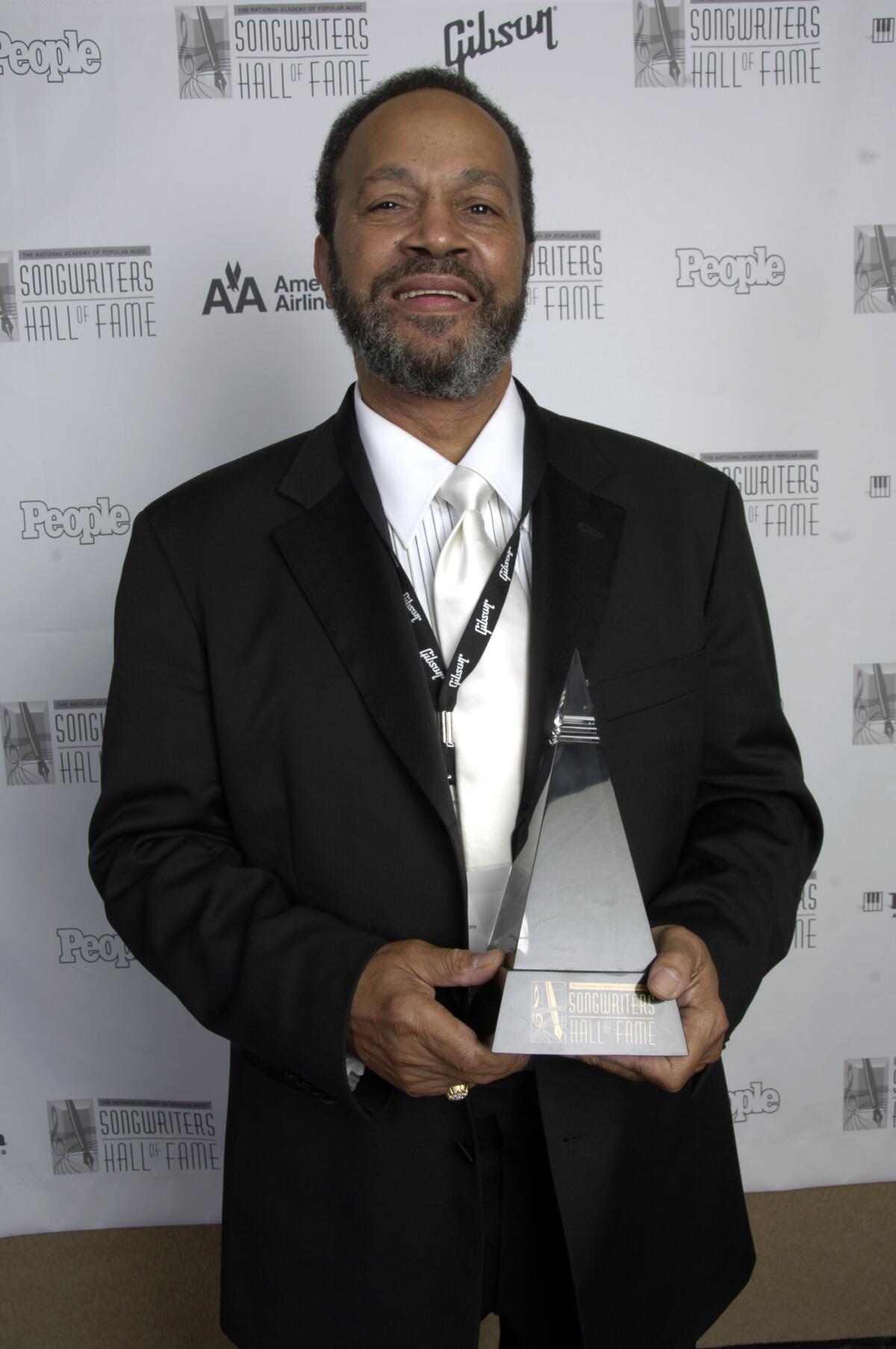 A man holds an award