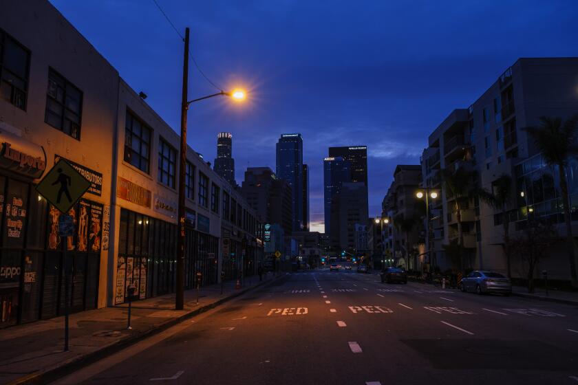 LOS ANGELES, CALIF. -- MONDAY, APRIL 6, 2020: Dusk settles as the Third street which is usually streaming with traffic, sits empty in downtown Los Angeles, Calif., on April 6, 2020. In California, there are more than 16,363 confirmed COVID-19 cases, according to a tally maintained by the Los Angeles Times. At least 387 have died. (Marcus Yam / Los Angeles Times)