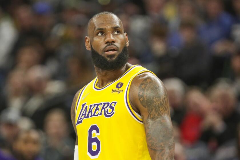 Los Angeles Lakers forward LeBron James looks on during an NBA basketball game.