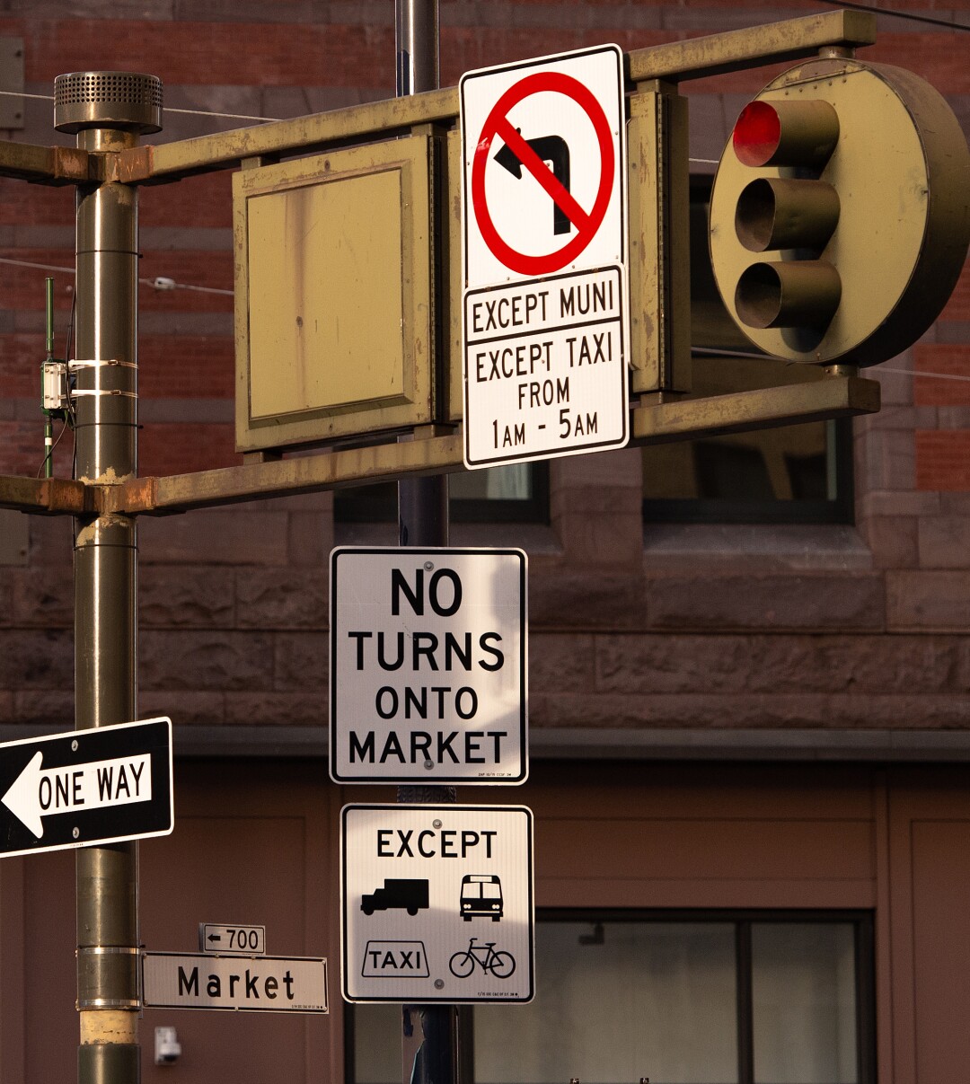 Posted signs warn of new traffic laws on a section of Market Street in San Francisco