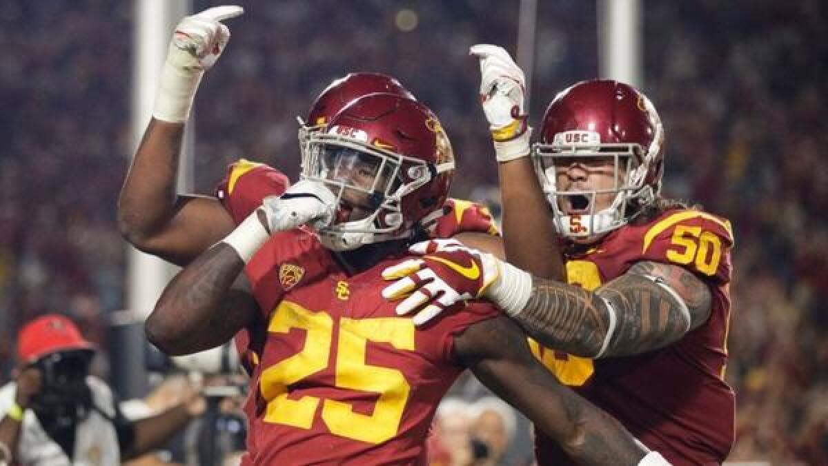 USC running back Ronald Jones II (25) celebrates a touchdown against Stanford with offensive linemen Toa Lobendahn (50) and Chuma Edoga (70) during the second half on Sept. 9.