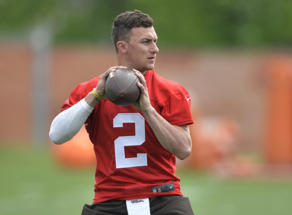 Cleveland Browns quarterback Johnny Manziel looks to pass during an organized training activity in Berea, Ohio, on May 30.