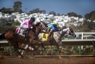 Triple Crown-winning jockey Victor Espinoza, riding California Song (4), pulls ahead of Tyler Baze riding Astra Star (11) in the fifth race on opening day at Del Mar Racetrack on July 16, 2015.
