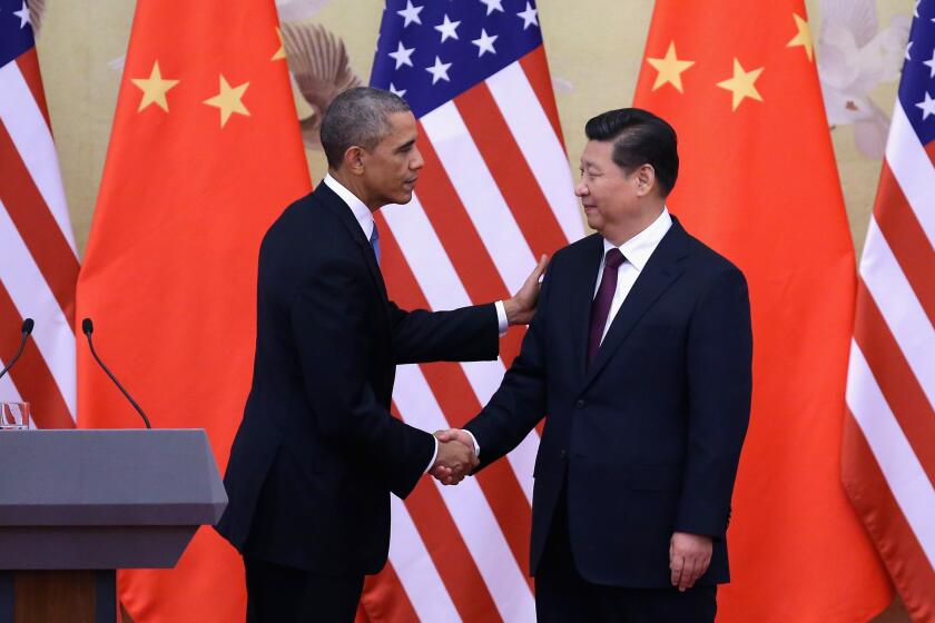 President Barack Obama shakes hands with Chinese President Xi Jinping, right, after a joint press conference at the Great Hall of People in Beijing, China.