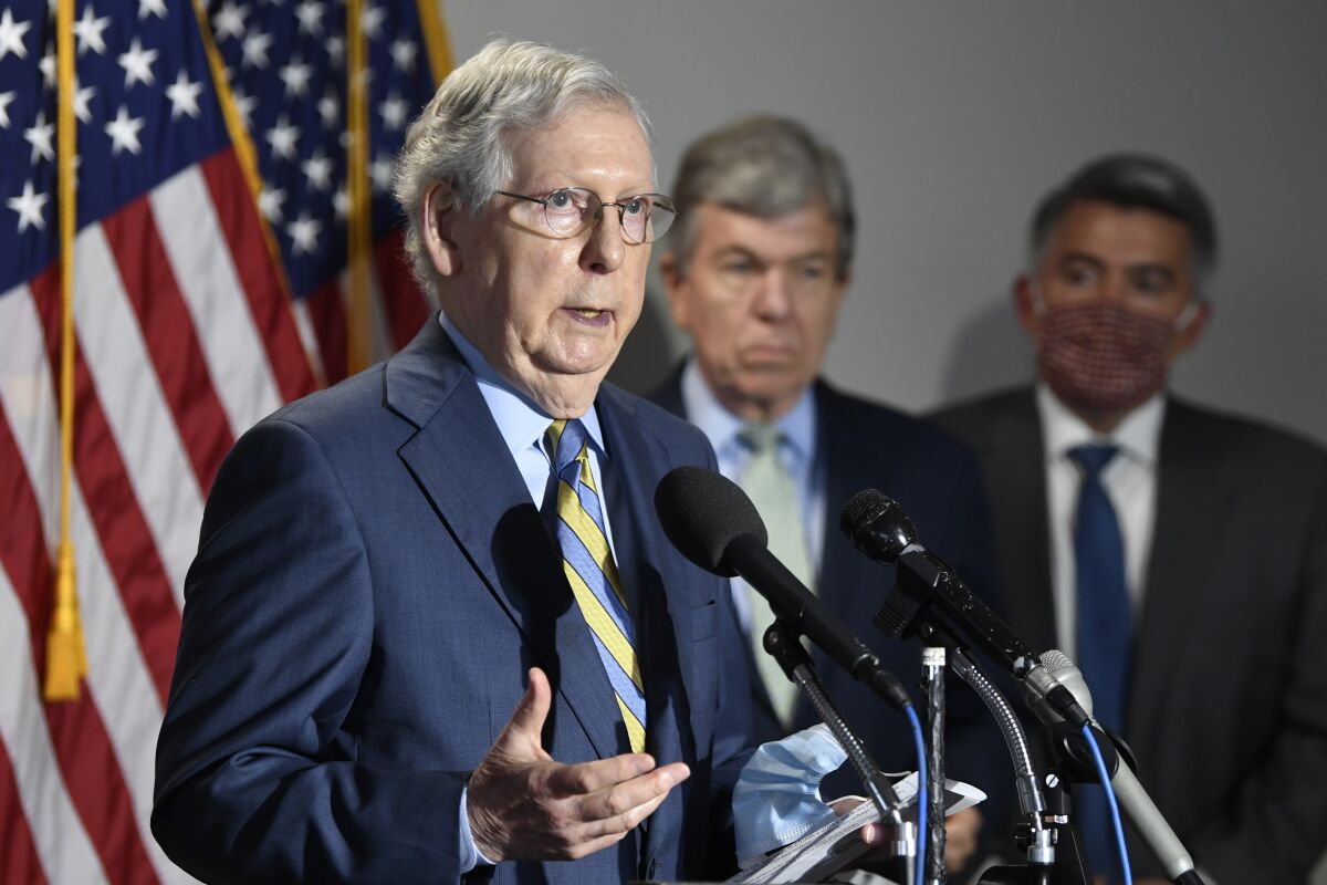 FILE - In this June 9, 2020, file photo Senate Majority Leader Mitch McConnell of Ky., left, speaks to reporters following the weekly Republican policy luncheon on Capitol Hill in Washington. Sen. Roy Blunt, R-Mo., center, and Sen. Cory Gardner, R-Colo., right, listen. Republican senators are fighting to save their majority against an onslaught of challengers in states once off limits to Democrats that are now hotbeds of the backlash to President Donald Trump and his allies on Capitol Hill. (AP Photo/Susan Walsh, File)