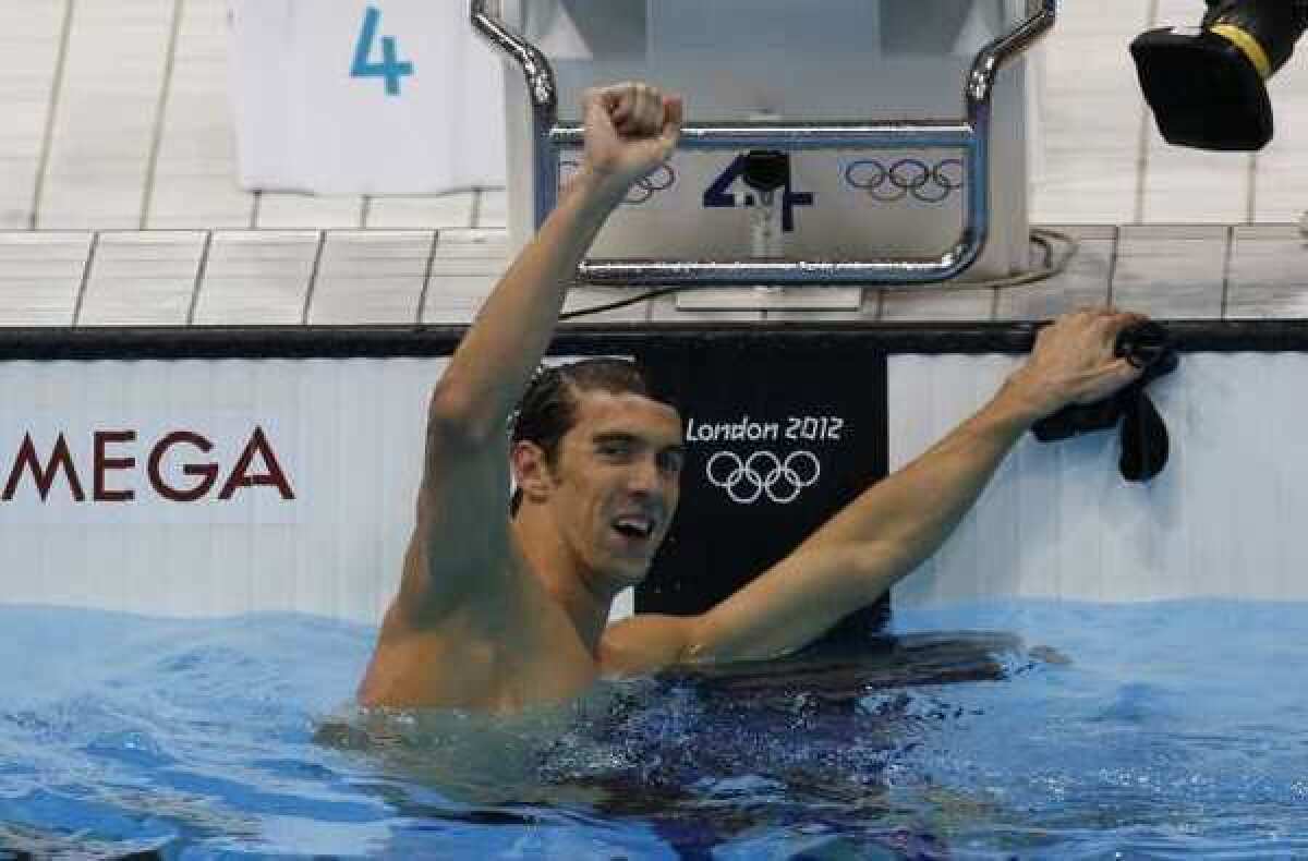 Michael Phelps celebrates after winning the 100-meter butterfly.