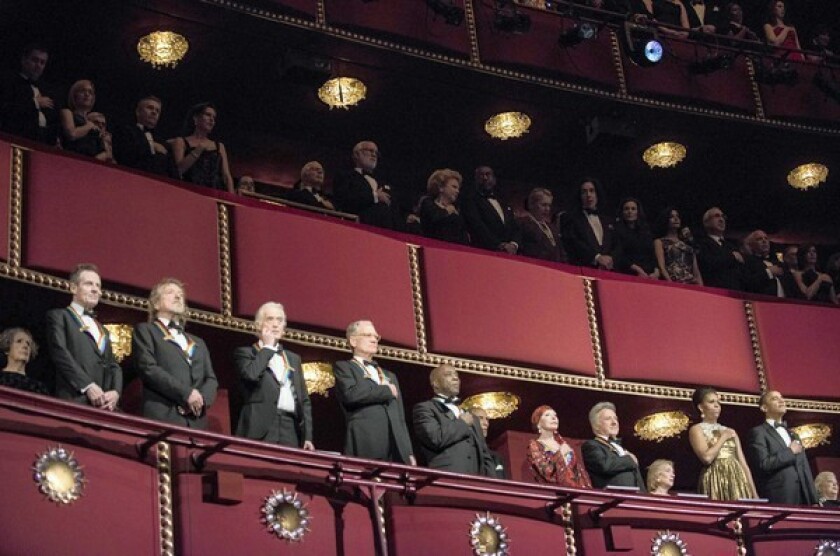 The Kennedy Center Honorees, from left, John Paul Jones, Robert Plant and Jimmy Page of Led Zeppelin, talk show host David Letterman, blues musician Buddy ballerina Natalia Makarova and actor Dustin Hoffman, First Lady Michelle Obama and President Obama listen to the national anthem during the 2012 Kennedy Center Honors at the Kennedy Center on Dec. 2, 2012, in Washington, DC.