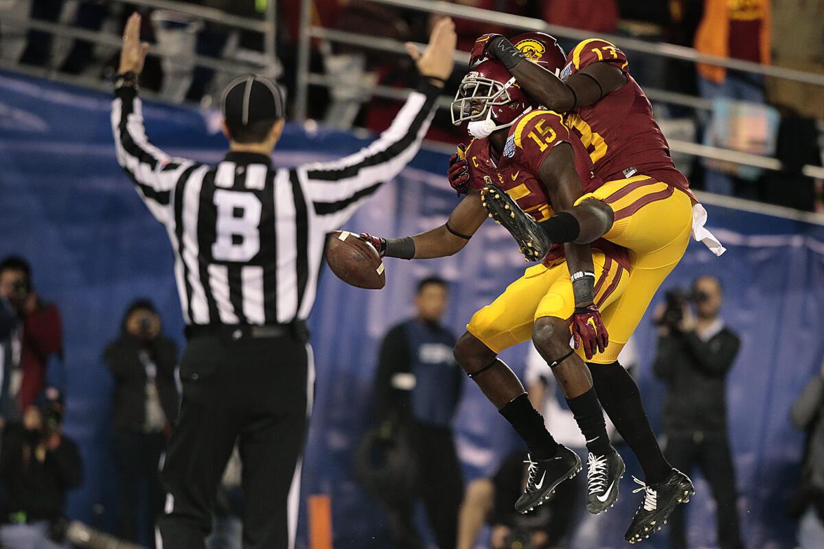 USC receiver Nelson Agholor (15) celebrates with teammate Bryce Dixon after scoring on a 17-yard reception in the second quarter.
