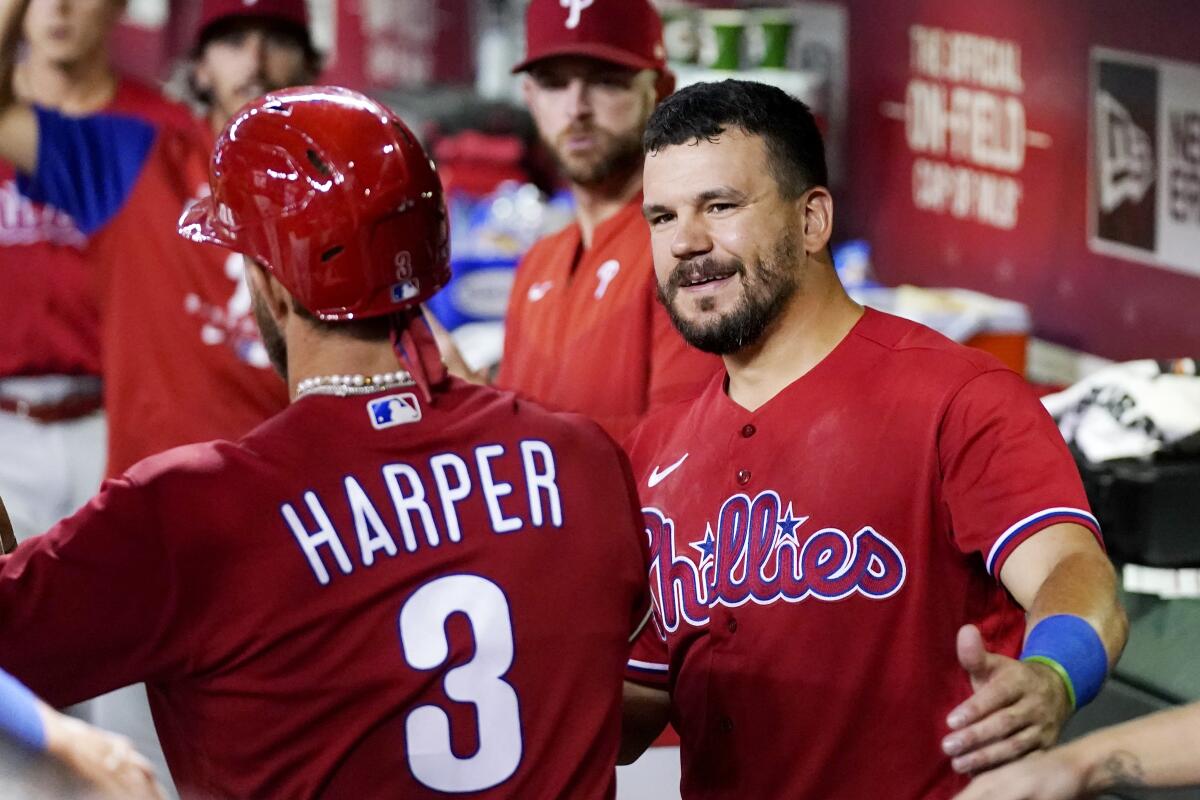 Philadelphia Phillies' Bryce Harper (3) is congratulated by Kyle Schwarber, right, after Harper scored against the Arizona Diamondbacks during the third inning of a baseball game Wednesday, Aug. 31, 2022, in Phoenix. (AP Photo/Ross D. Franklin)