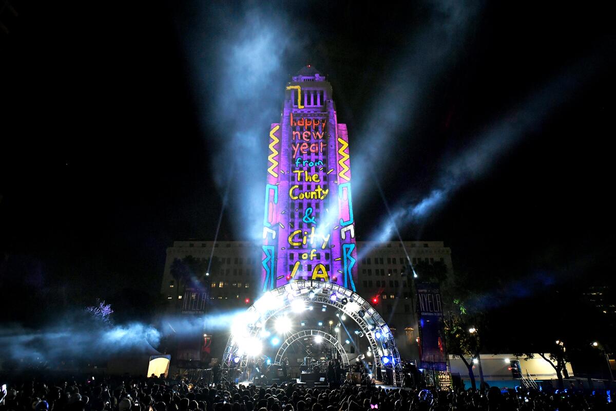 City Hall in downtown LA lit up with a light installation. 