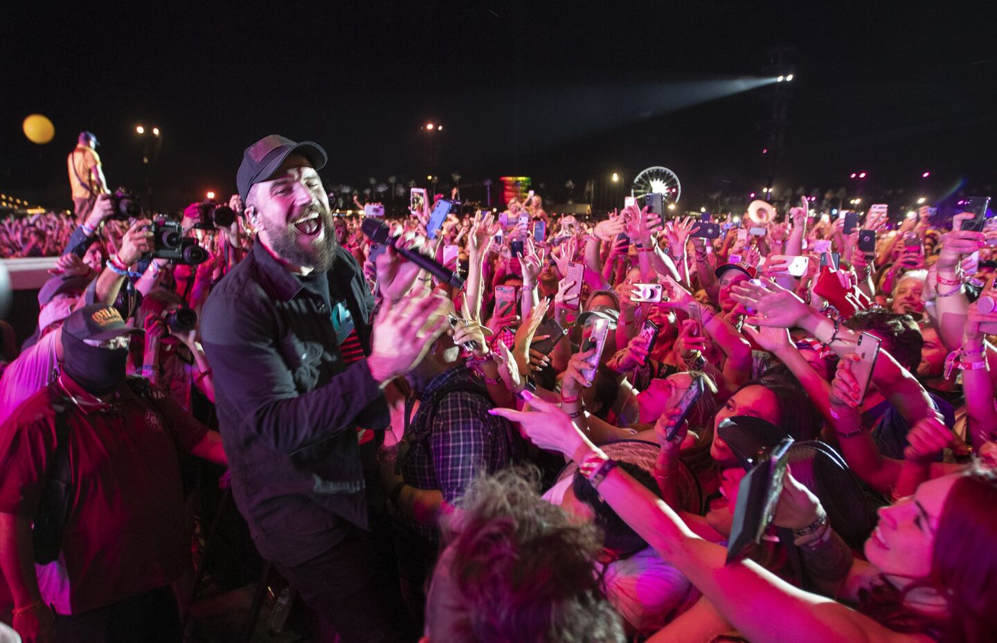 After climbing off stage, Saturday's headliner Sam Hunt sings up close with fans as he performs on the Mane Stage on the second of the three-day 2019 Stagecoach Country Music Festival.