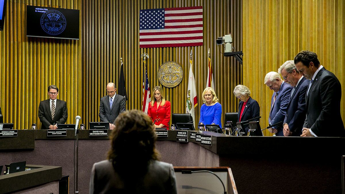 Members of the San Diego County Board of Supervisors bow their heads during a benediction at a swearing-in ceremony in January at the County Administration Center.
