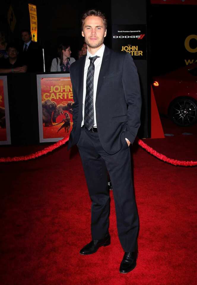 Taylor Kitsch walks the red carpet at the "John Carter" premiere.