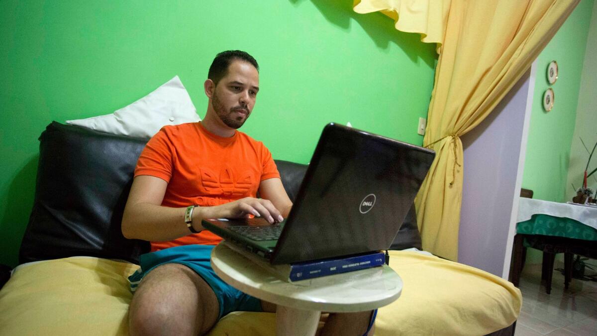 A man uses his laptop to access the Internet.