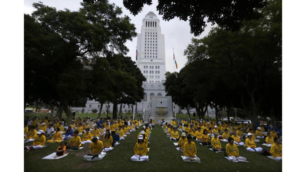Falun Dafa followers meditate on the south lawn of Los Angeles City Hall on Thursday.