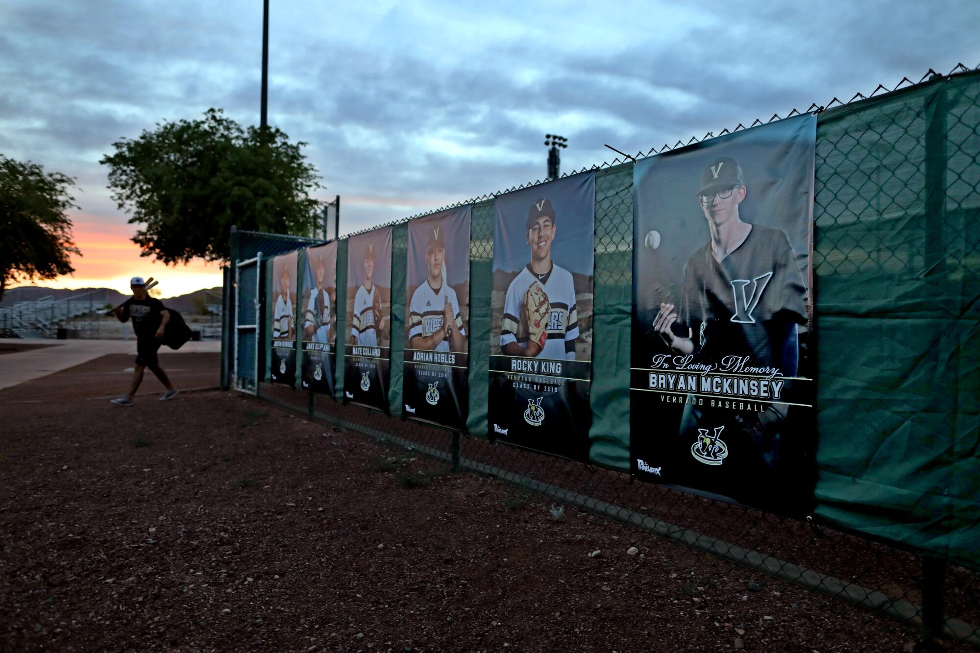 A banner in memory of Bryan McKinsey, far right, hangs along with banners for senior class members of the Verrado High School baseball team in Buckeye, Ariz.