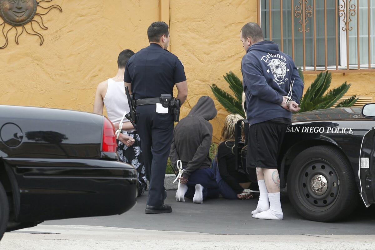 San Diego police and other agencies arrested 14 gang members and associates in San Diego Wednesday morning, while another two were nabbed in Arizona and one in New Jersey. — John Gibbins