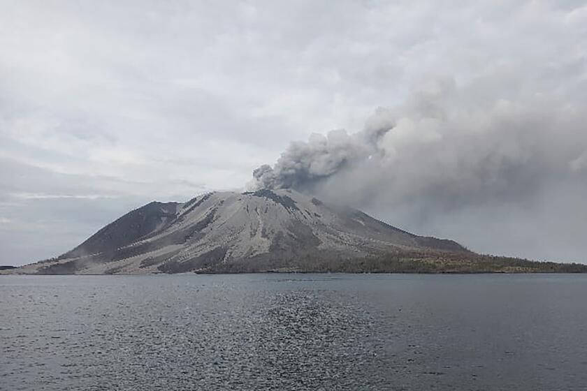 Mount Ruang volcano is seen during the eruption from Tagulandang island, Indonesia, Wednesday, Wednesday, May 1, 2024. Indonesia's Mount Ruang volcano erupted Tuesday for a second time in two weeks, spewing ash almost 2 kilometers (more than a mile) into the sky, closing an airport and peppering nearby villages with debris.(AP Photo/ Hendra Ambalao)