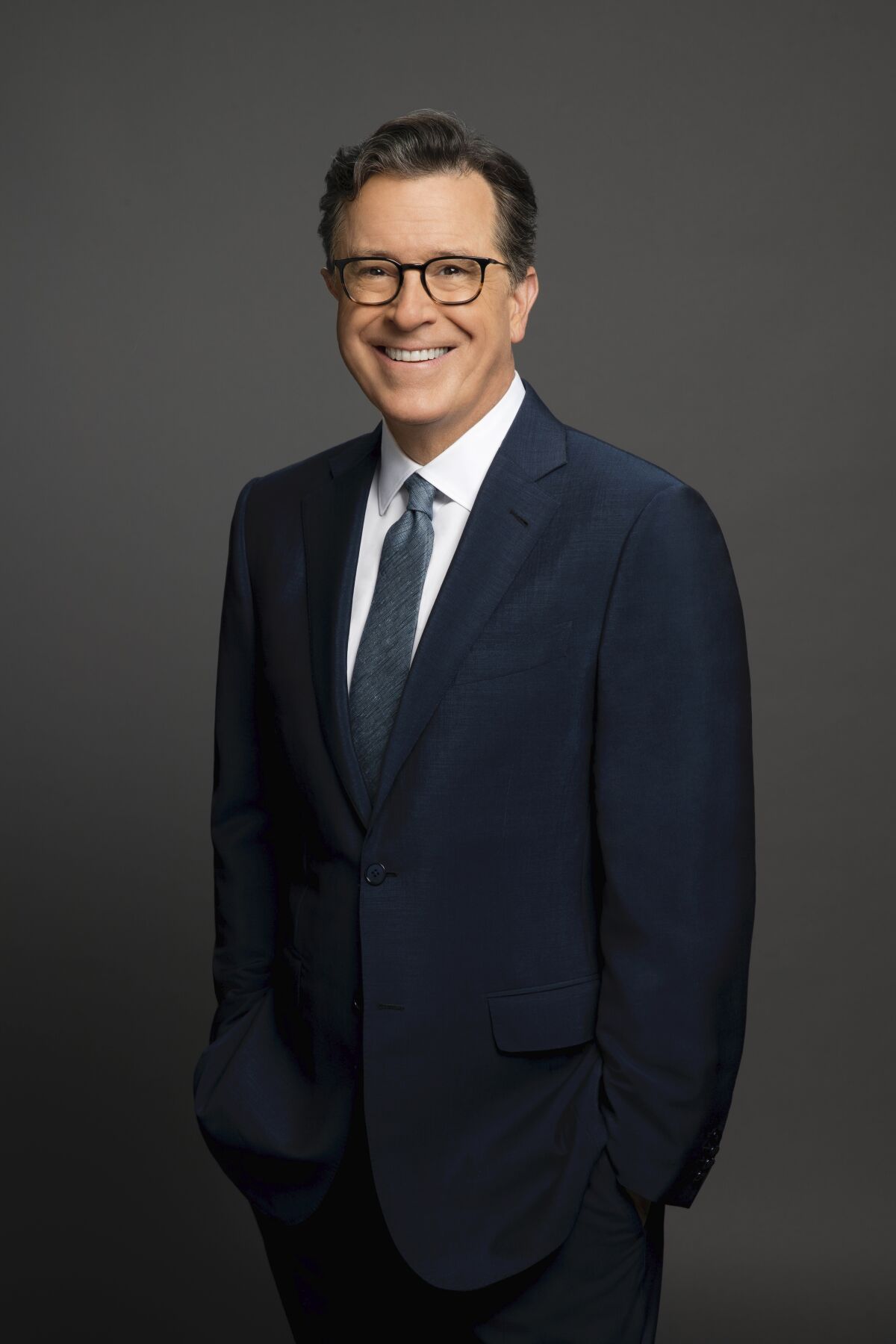 Portrait of a man in a suit standing and smiling